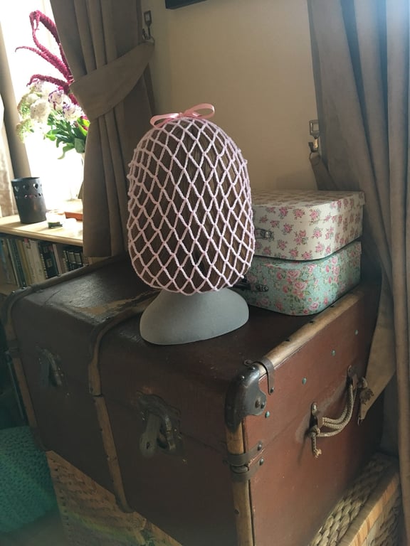 Pale pink 1940s style snood hairnet with a pink ribbon for an authentic vintage 