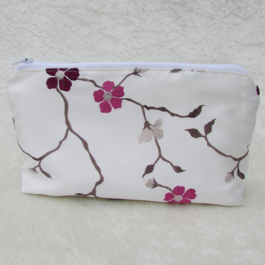 Ivory cosmetic bag with purple and pink floral pattern