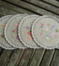 Round embroidered and reversible fabric coasters. - Image 1