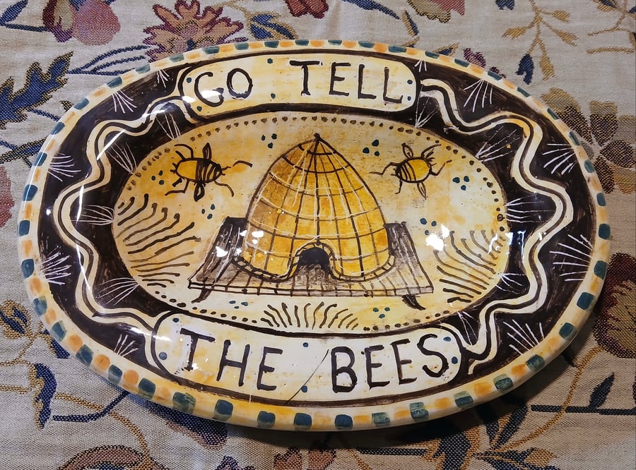 Oval slip ware dish with hand painted bee skep