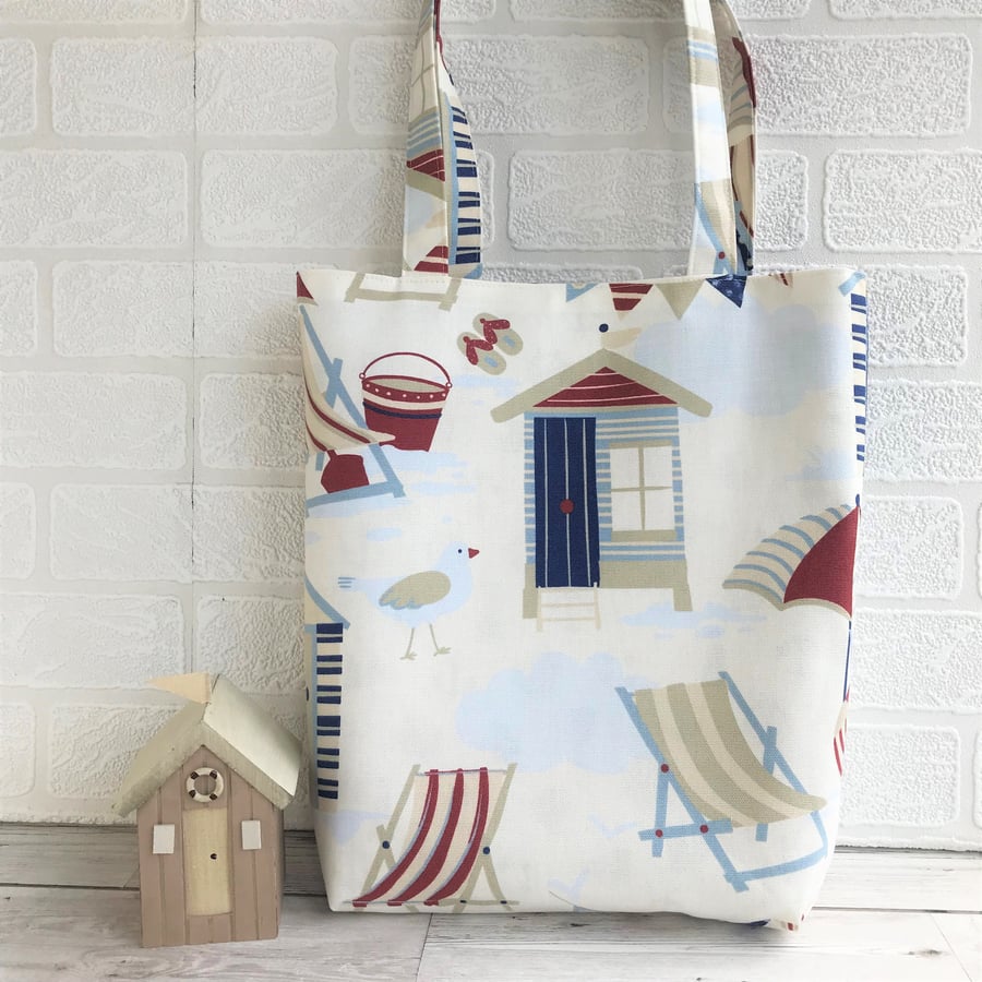 Nautical seaside tote bag with blue and red beach huts and deck chairs