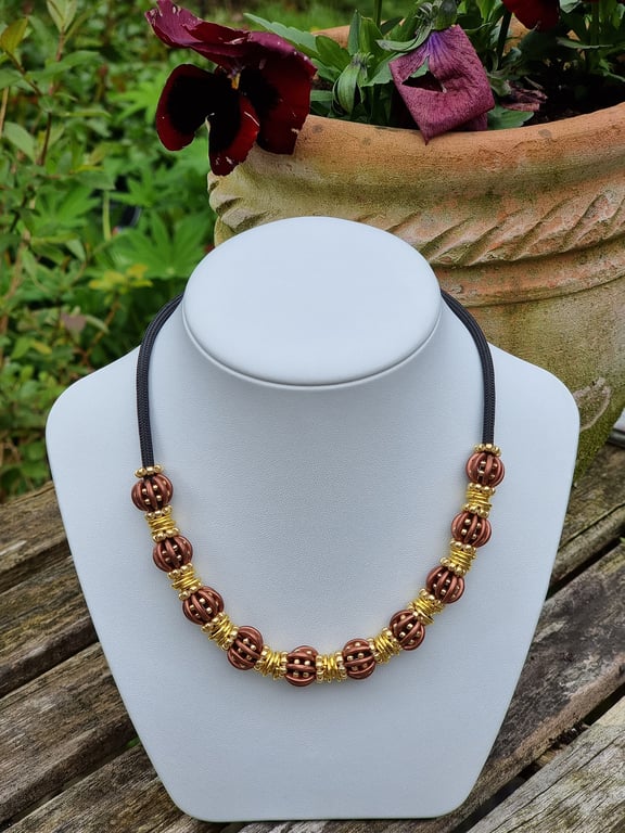 Beaded Necklace 16 inches with 10 beaded beads in Brown and Gold. Adjustable 