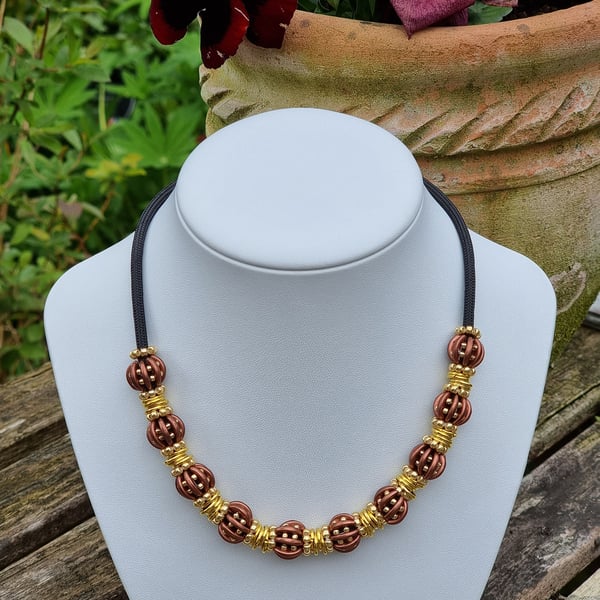 Beaded Necklace 16 inches with 10 beaded beads in Brown and Gold. Adjustable 