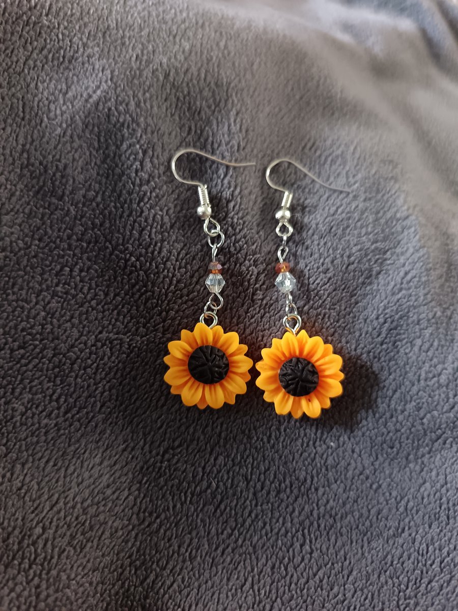 Sunflower charm dangle earrings with clear and orange glass beads
