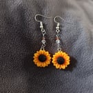 Sunflower charm dangle earrings with clear and orange glass beads