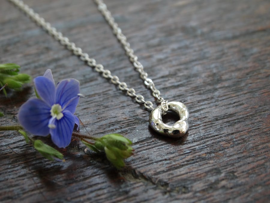 Tiny hagstone charm pendant - molten silver - recycled silver