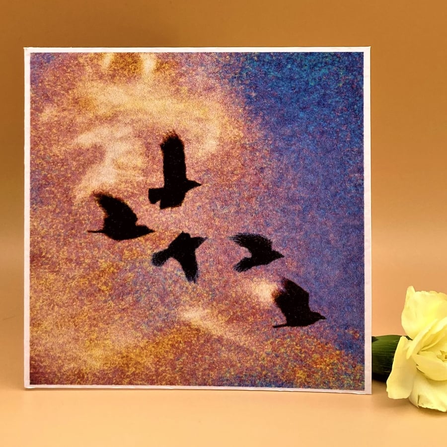 Blank Greetings Card, flying crows against a rainbow coloured sky, no message. 