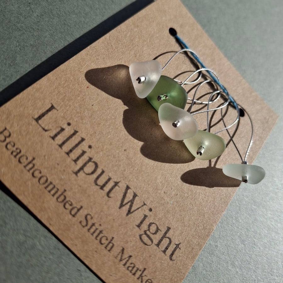 Five green and white sea glass stitch markers