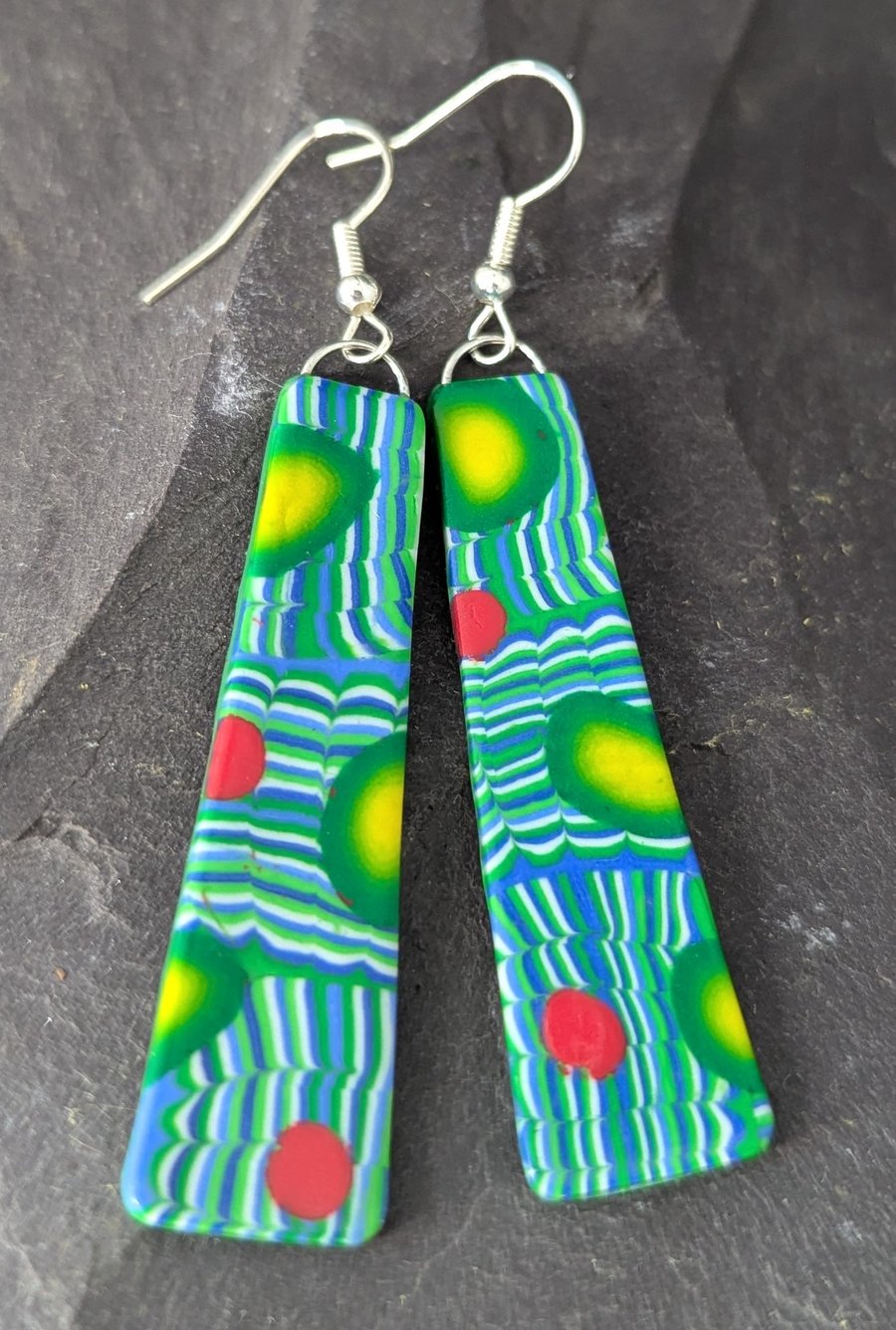 Long teal green earrings.