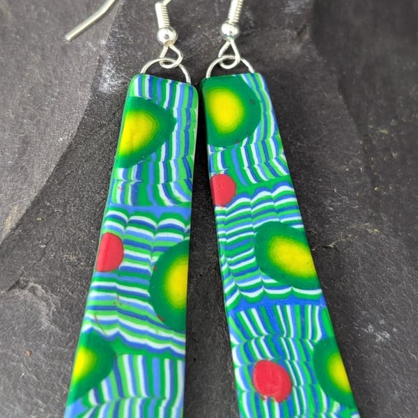 Long teal green earrings.