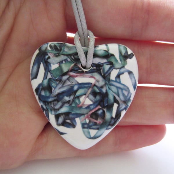 Tousled Ribbon Pattern Heart Shaped Ceramic Pendant on Grey Cord with Clasp