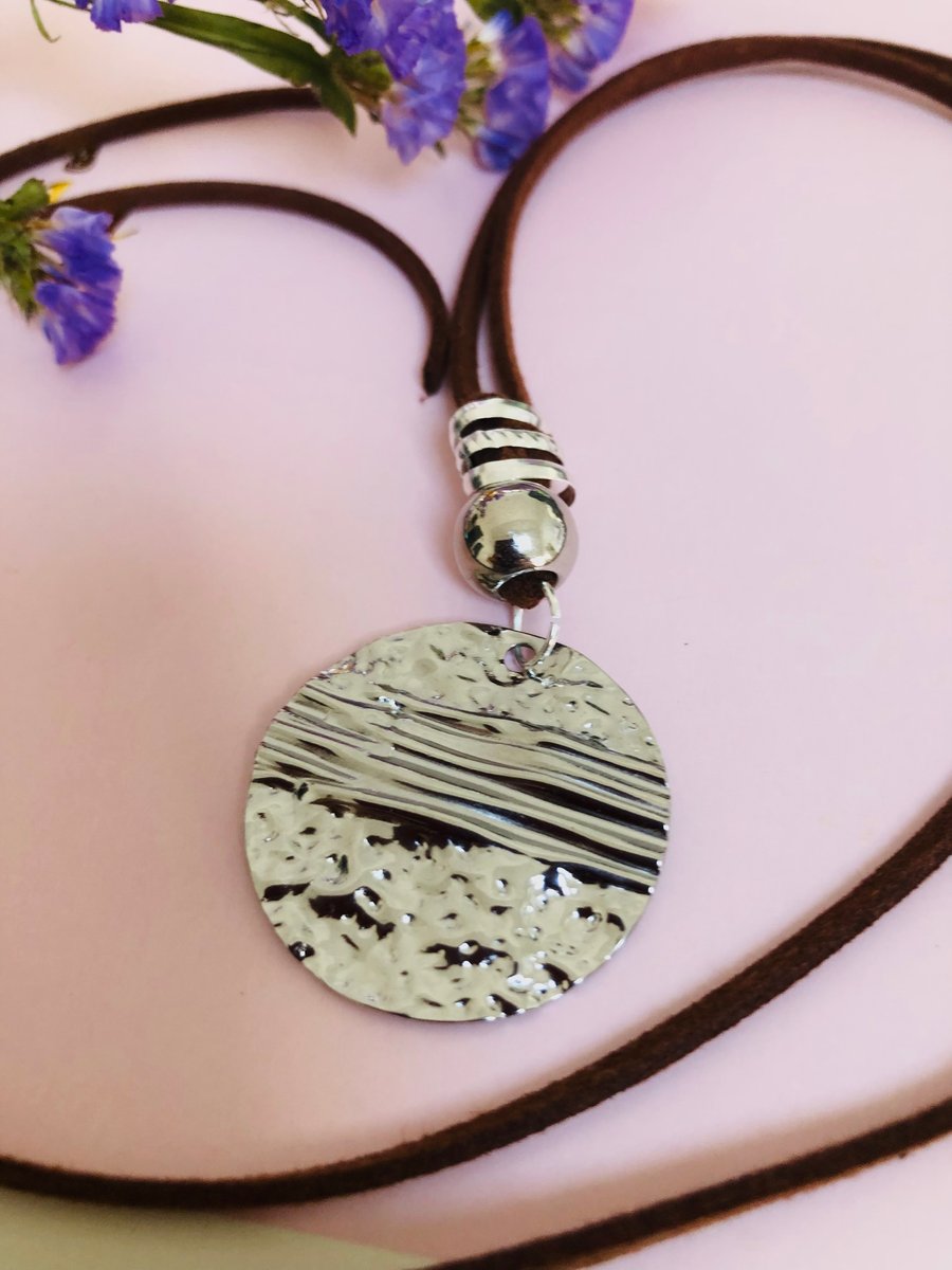 Boho beach style hammered silver coloured pendant on necklace
