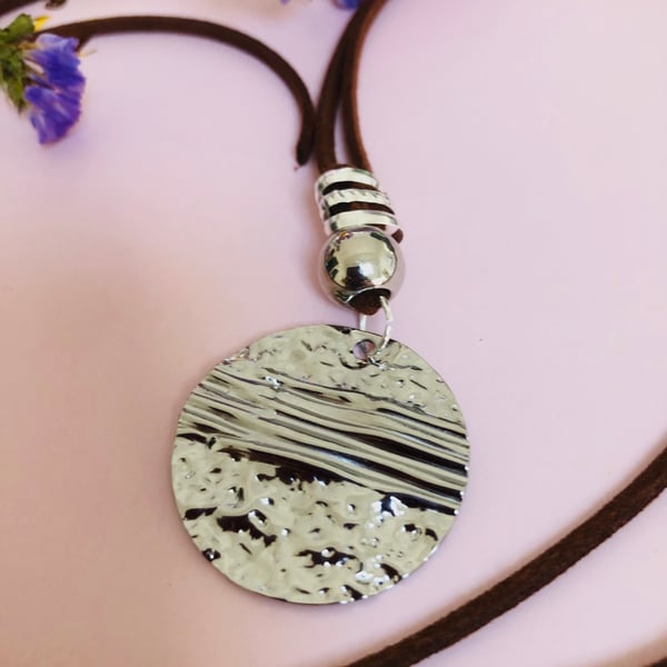 Boho beach style hammered silver coloured pendant on necklace