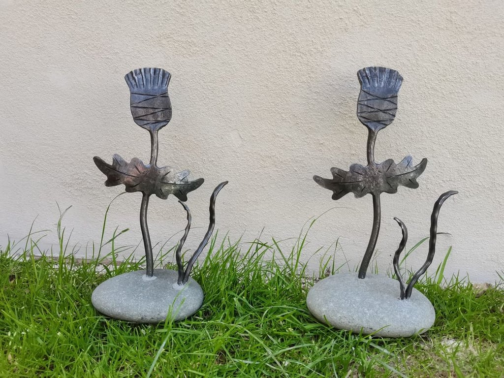 Hand crafted thistle sculpture mounted in stone base