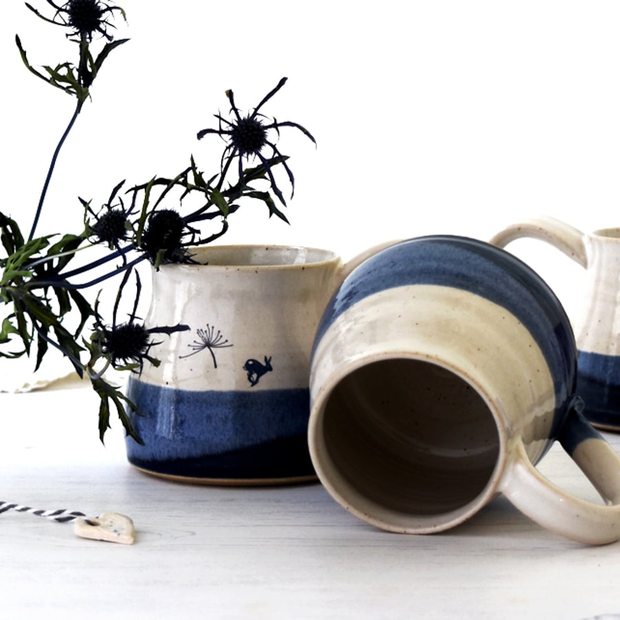 Blue and white ceramic mug with leaping hare  - handmade illustrated pottery