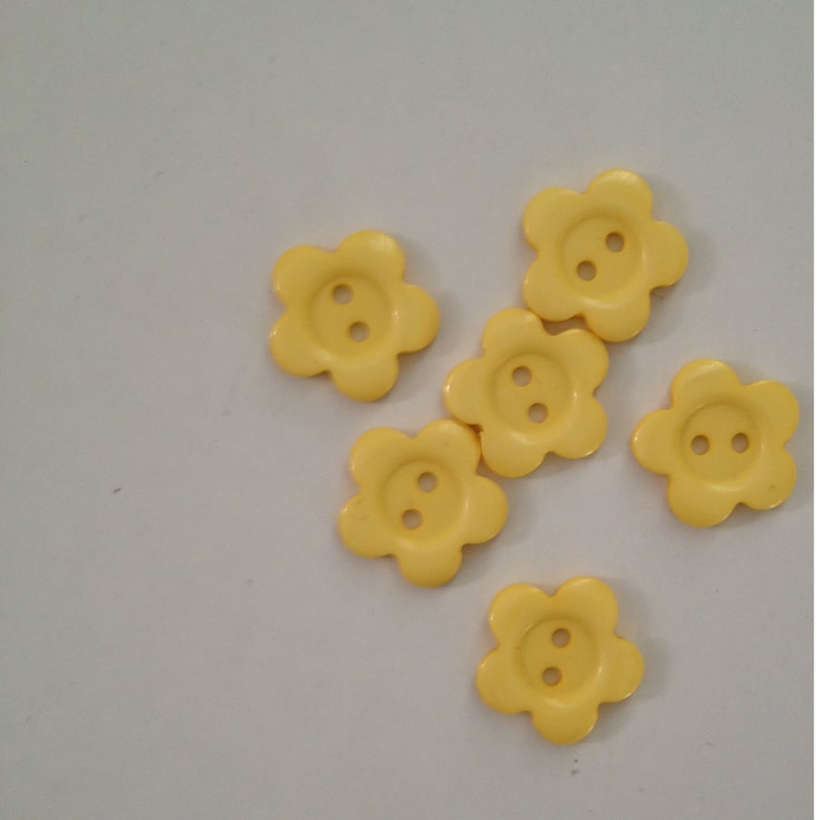 6 pale yellow flower buttons.