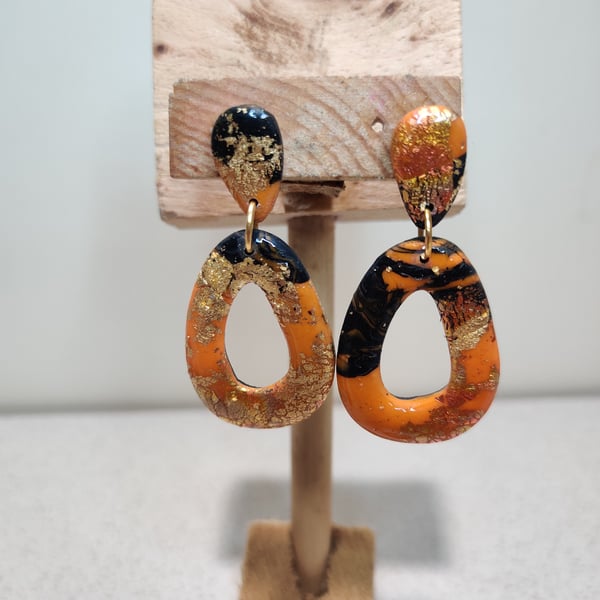 Orange galaxy hollow pebble earrings