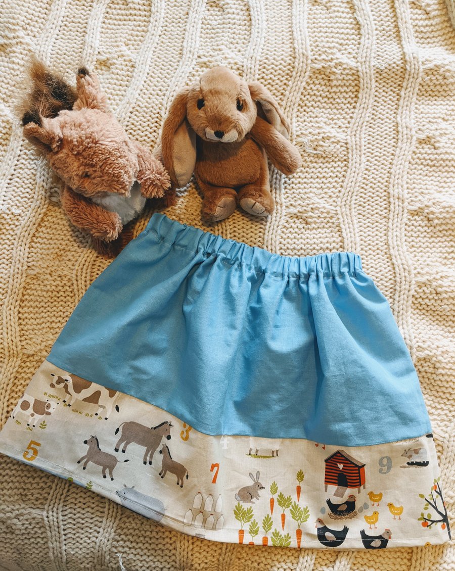 Blue children's skirt with barnyard fabric trim, age 2-3