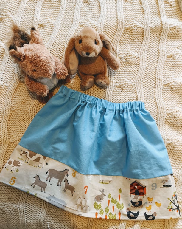 Blue children's skirt with barnyard fabric trim, age 2-3