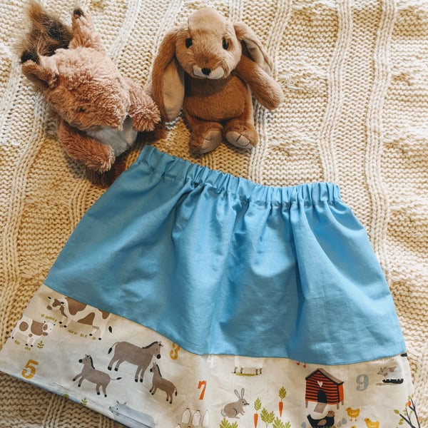 Blue children's skirt with barnyard fabric trim, age 2-3