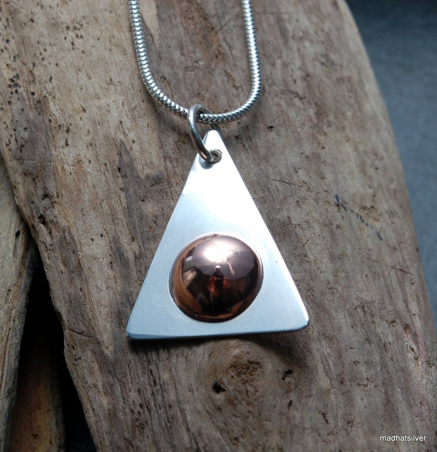 Silver pendant with copper dome