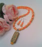 Peach Rectangle with Floral Pattern on an Orange and Peach Necklace & Earrings  - Image 1