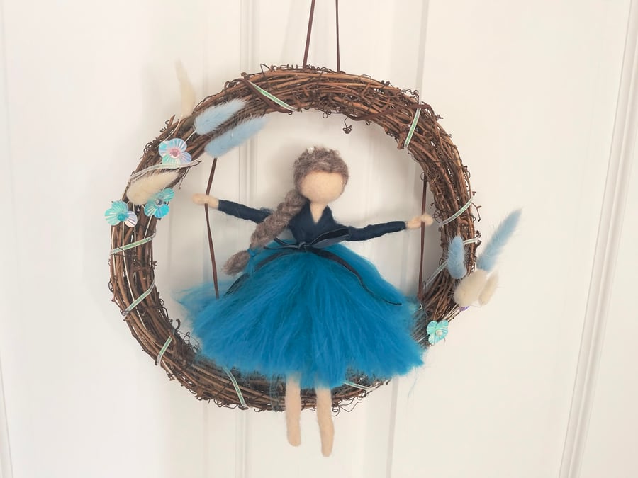 Sapphire on swing in wreath