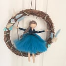 Sapphire on swing in wreath
