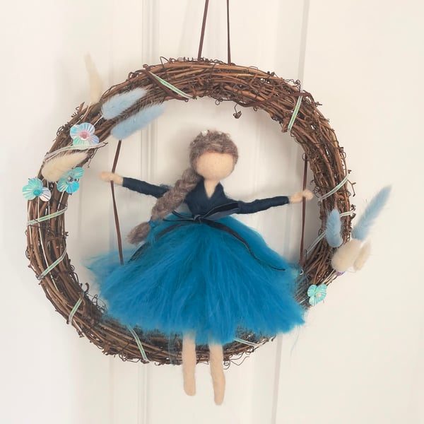Sapphire on swing in wreath