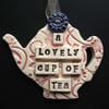 Ceramic teapot decoration with button flower