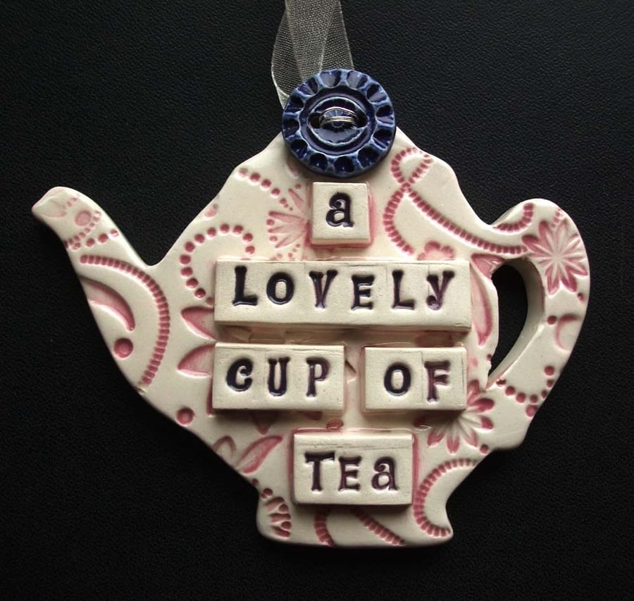 Ceramic teapot decoration with button flower