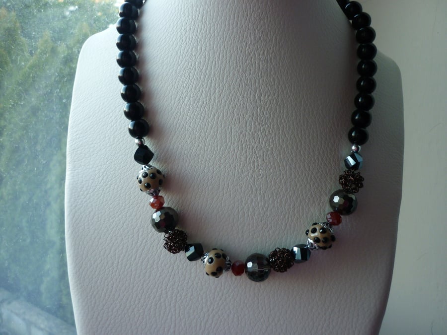 BLACK, BRONZE, BEIGE, BROWN AND SILVER NECKLACE.
