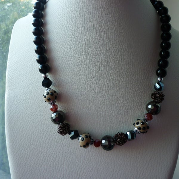 BLACK, BRONZE, BEIGE, BROWN AND SILVER NECKLACE.