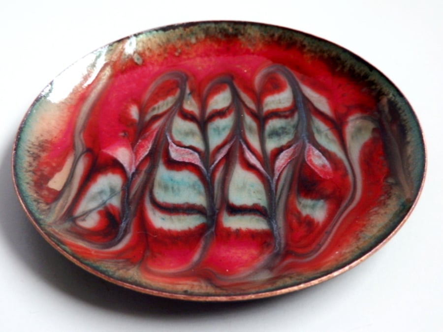 enamelled dish: scrolled pale green and gold, on red over clear