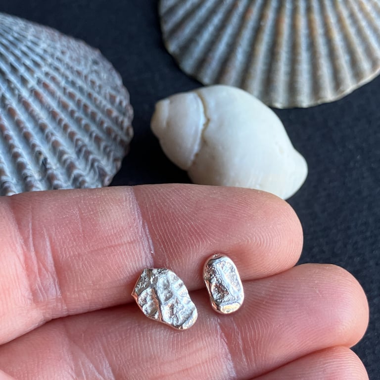 Mismatch pair of recycled silver stud earrings.