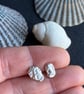 Mismatch pair of recycled silver stud earrings.