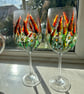 A pair of hand painted and fired wine glasses by Andrew Jenkins