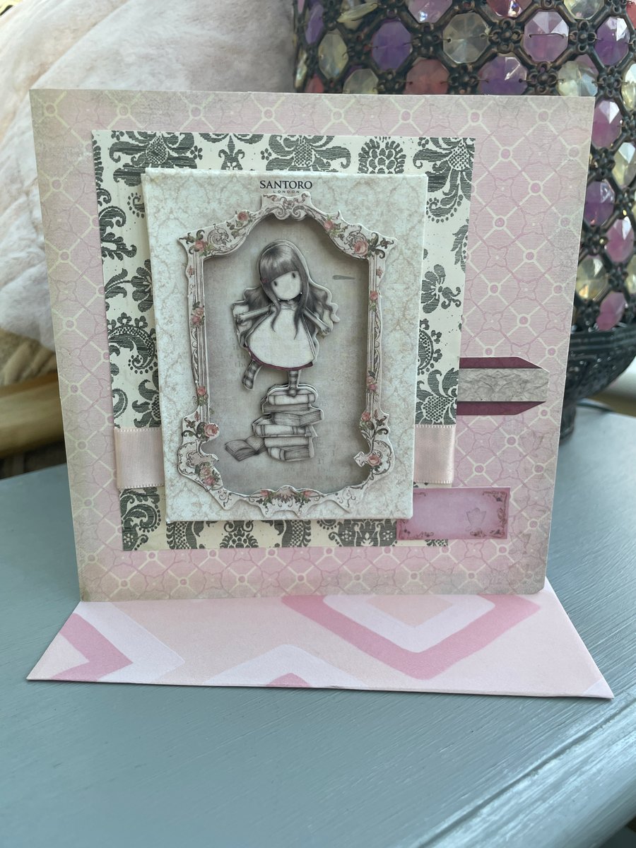 Gorjuss girl framed girl balancing on a pile of books