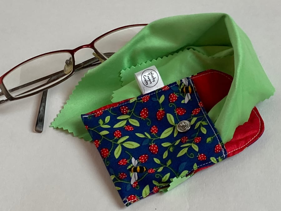 Spectacles cleaning cloth and pouch. Strawberries and bees. Sparkling glasses.