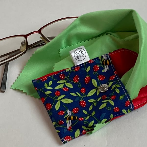 Spectacles cleaning cloth and pouch. Strawberries and bees. Sparkling glasses.
