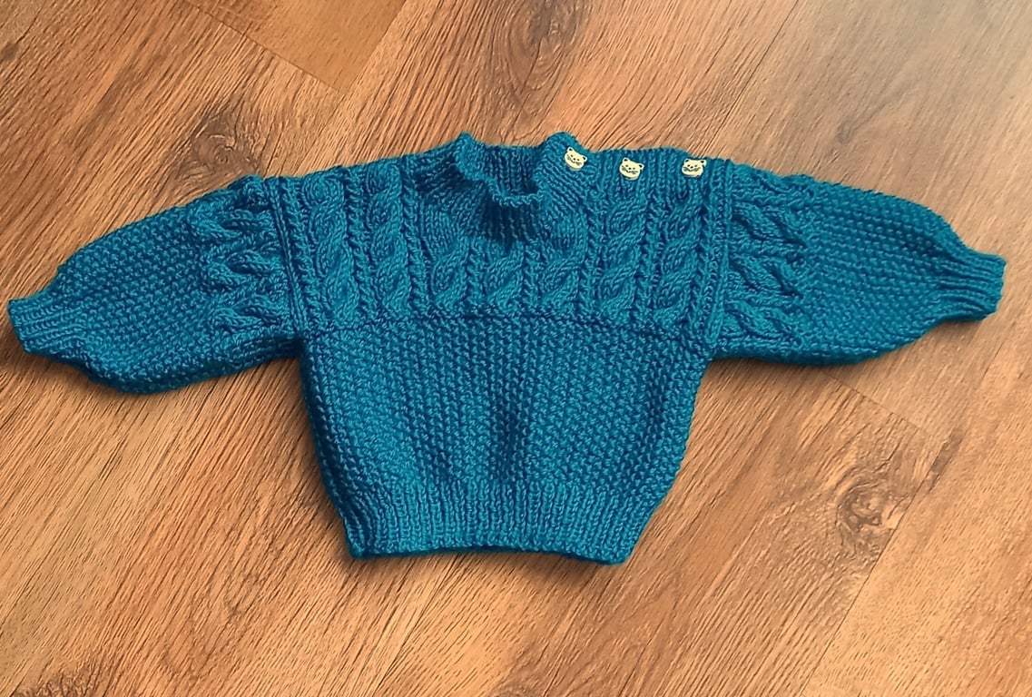 Hand knitted baby boys jumper with shoulder fastening 
