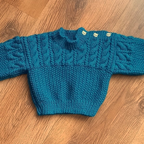 Hand knitted baby boys jumper with shoulder fastening 