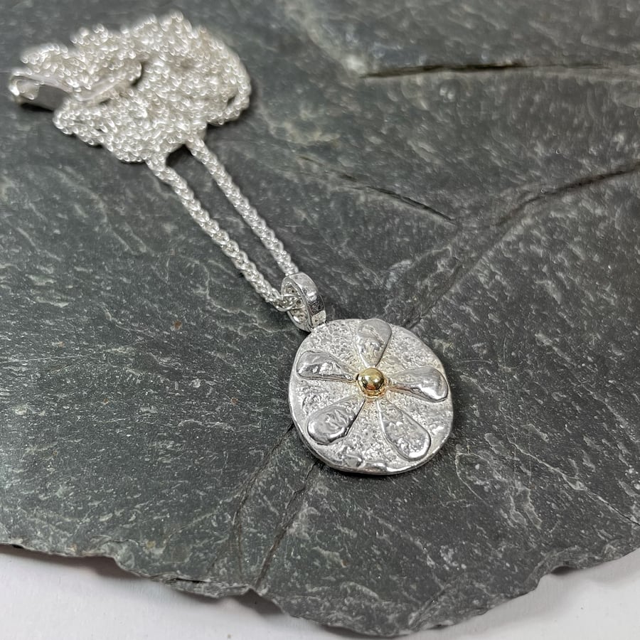 Silver and gold flower pendant on silver chain