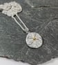 Silver and gold flower pendant on silver chain