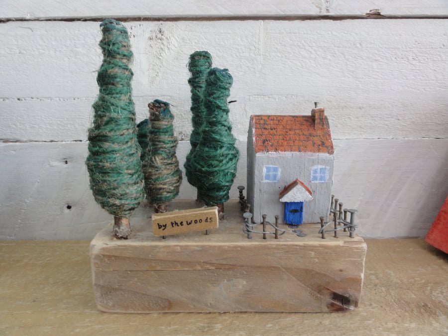 Small wooden house and a wooded area - scene from reclaimed materials