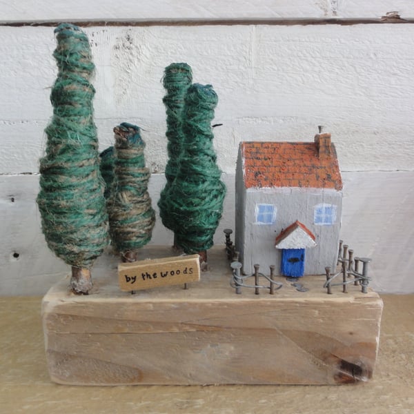 Small wooden house and a wooded area - scene from reclaimed materials