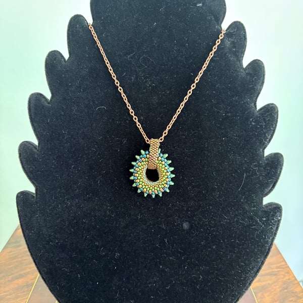 Spiky beaded donut pendant