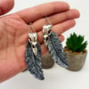 Huginn and Muninn bird skull and feather statement earrings in silver