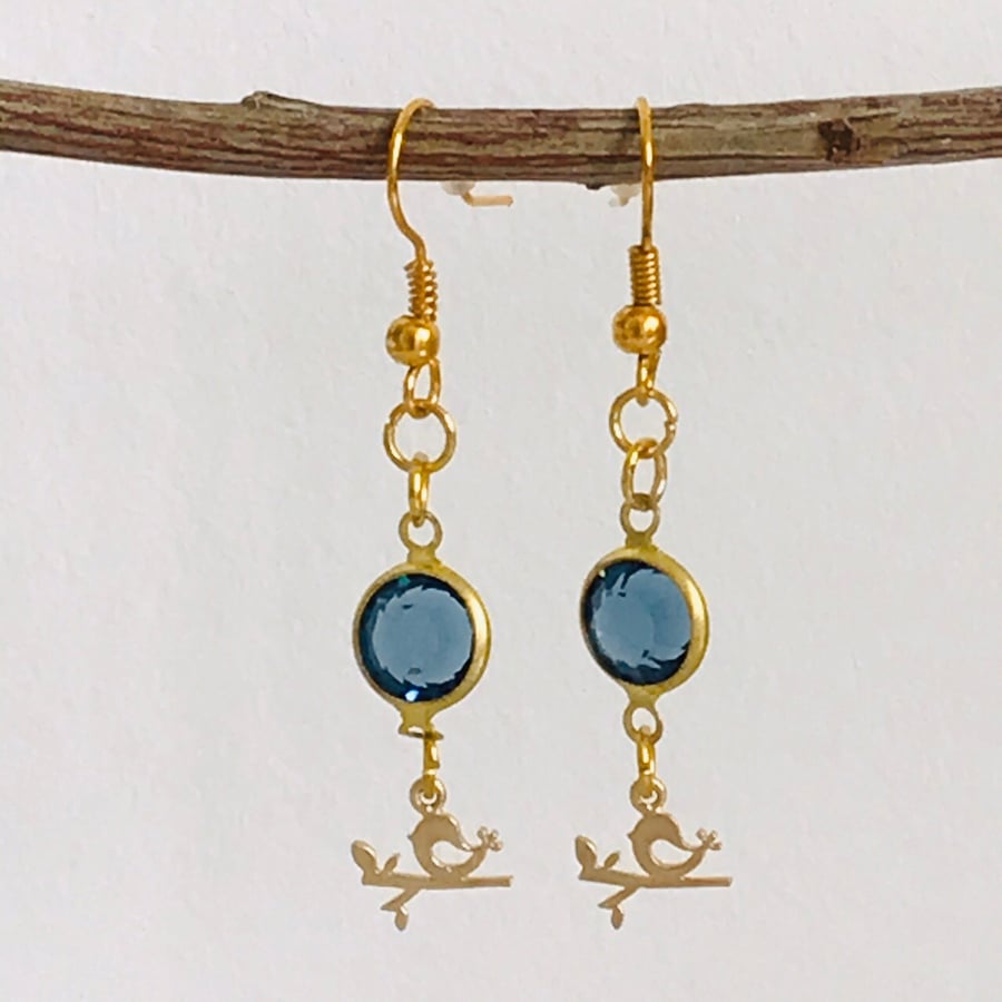 Blue glass gold plated dangle earrings with bird charms
