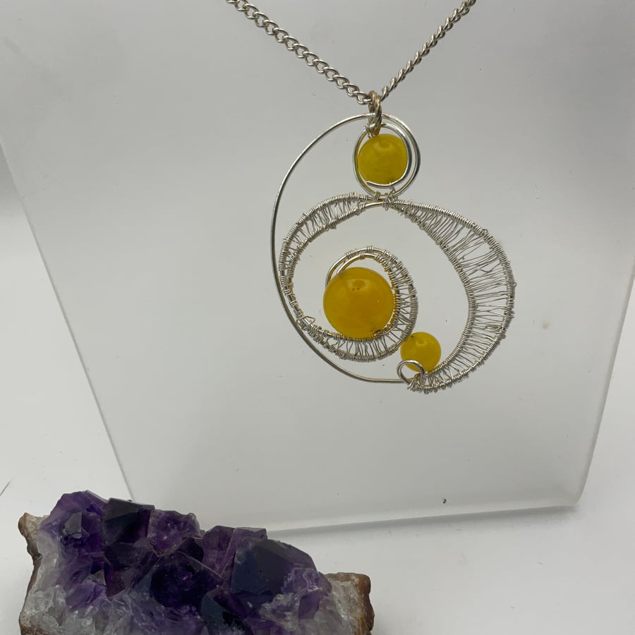 A fashionable yellow ciitrine  silver wired pendant